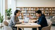 © Alva - A mature female professor and a young male student studying together in a modern university library.