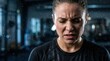 © Lamduan - Demonstrating grit and resolve to conquer challenges, an unwavering athlete trains intensely in the gym with sweat glistening on their face.