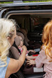 © Nata Segueza/Stocksy - A mother holds her child in a child car seat.