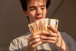 © Dani_Solare - Teenager reacting with shock to fanned euro banknotes
