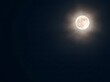 © la - Glowing Full Moon in Dark Night Sky with Bright Lunar Corona Effect