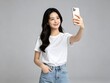 © aziseptian - Young smiling woman taking a selfie with her smartphone