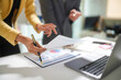 © Cavan Images - Business Team Reviewing Financial Reports in Office