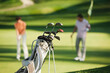 © Westend61 - Golf bag and club with man and woman playing on course in Italy