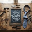 © Ella - Happy Fathers Day message on a chalkboard tag with frame of tools and ties on a wooden background, vintage styling