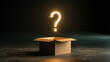 © Momin Photo Gallery - Elegent photo of A glowing golden question mark floats above an open cardboard box in a dark room. Represents mystery, product surprise, or unknown solution concept.