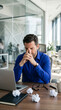 © Inspire Shots Hub - Stressed businessman rubbing his temples at desk with laptop and crumpled papers, symbolizing burnout and overwhelm in a modern office environment, showcasing mental strain.