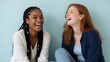 © panumas - Two Laughing Multiracial Friends Sharing Joy