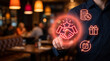 © SYATRI RAWU - Modern customer loyalty program and partnership concept with glowing red icons being touched by a hand in a blurry restaurant environment.