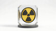 © faizah - A striking yellow and black nuclear radiation symbol, encased in a clear glass cube, elegantly displayed on a dark grey base, representing scientific hazards, atomic power, and potential danger