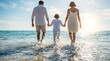 © SnapSpark Studios - Family walking together through shallow ocean surf toward bright horizon sun