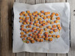 © Hera Yeko - Fresh cherry tomatoes seasoned with olive oil and herbs on a baking tray