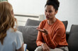 © lordn - Woman gestures while discussing a difficult personal issue with a therapist during a private counseling and mental health support session