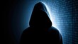 © Generative AI - Silhouette of anonymous hooded hacker figure standing against glowing blue binary code background suggesting cybercrime and digital security threats