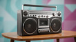 © Angavlan - Sleek black retro boombox on wooden table with metallic accents and speakers. Black retro boombox features cassette player and chrome buttons. Authentic black retro boombox concept for advertising.