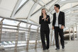 © eakgrungenerd - Business professionals having friendly workplace conversation outdoor office, representing teamwork, communication, corporate networking, collaboration, career growth and partnership.