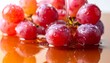 © WIVA - Vibrant red grapes glistening with fresh water droplets, reflecting their juicy allure on a wet surface, embodying nature's sweet bounty and healthful refreshment