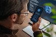 © Arsenii - Close up of man using AI chatbot app on his smartphone for business tips while artificial intelligence assistant or agent on his computer helps him with work and daily tasks on background. Copy space