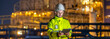 © BESTIMAGE - Technician talk assignment petroleum engineering in oil refinery briefing guidance operation at fuel industrial plant Male engineer holding tablet inspecting near lighted oil refinery at night