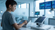 © Moonroad - Student testing solar tracking system in laboratory with photovoltaic panel, control device, monitor, and focused expression during renewable energy experiment