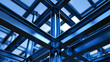 © Micro Pix - Blue steel beams form a geometric structural framework for a modern building. Architecture and construction development concept.
