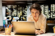 © DC Studio - Businesswoman documents essential ideas from a PC screen on paper, planning and scheduling tasks late at night while handwriting notes for a presentation that reflects business objectives.