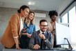 © NDABCREATIVITY - Group of young business people working as a team and communicating in corporate office