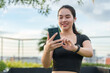 © crizzystudio - Woman using phone and smartwatch checking fitness data