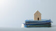 © Piya W. - Real estate dispute mini house model stack document paper serious legal concept financial property debt problem tension insurance plan