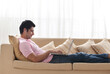 © IndiaPix - Young man using laptop while listening to music