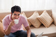 © IndiaPix - Portrait of handsome man drinking coffee with laptop