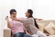 © IndiaPix - Playful young man keeping remote control away from woman