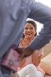 © IndiaPix - Man hiding surprise gift from happy woman