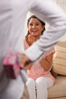 © IndiaPix - Excited young woman looking at man holding gift