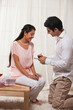 © IndiaPix - Caring young man giving cake to woman on birthday