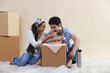 © IndiaPix - Loving young couple sharing food together at their new home