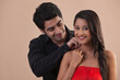 © IndiaPix - Handsome young man placing necklace on woman's neck