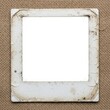 © ilham - Vintage blank photographic slide frame on burlap texture background.