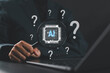 © Goodtime - AI question analysis and artificial intelligence research concept. Woman using laptop with magnifying glass, AI chip and question marks showing data discovery, problem solving, smart decision support.