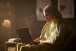 © DragonImages - Caucasian young woman working on laptop at home during evening, representing remote work and online education. Image suitable for e-learning and freelance business marketing