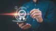 © Shehzad - Professional hand using stylus pen interacting with digital quality assurance certification badge hologram interface screen with interact glowing digital