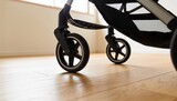 Highlighting stroller front caster wheels resting on oak floor in sunlit room, with mesh basket