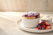 © Utis - A delectable berry souffle served with whipped cream and fresh fruits, perfect for a delightful dessert experience.