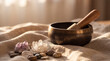 © Vivid Pixel - Tibetan singing bowl with wooden mallet, healing crystals and smooth stones on linen in warm sunlight for meditation, sound therapy and holistic wellness