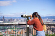 © leungchopan - Woman looking through public telescope in Taipei Taiwan
