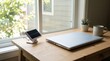 © primipil - Portable Solar Panel Charger on Wooden Desk with Laptop Near Window. Concept of green energy, clean energy. Copy space.