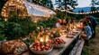 © Up - Farm-to-table outdoor dinner party next to an organic vegetable garden at twilight