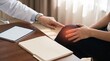 © JUST 4U STOCK  - Doctor performing a physical examination of a patient with knee pain during a medical consultation in a clinic office