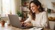 © FryArt - Happy woman using a laptop at home