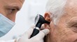 © Image - Professional Medical Examination of Senior Patient Ear Using an Otoscope in Clinical Setting